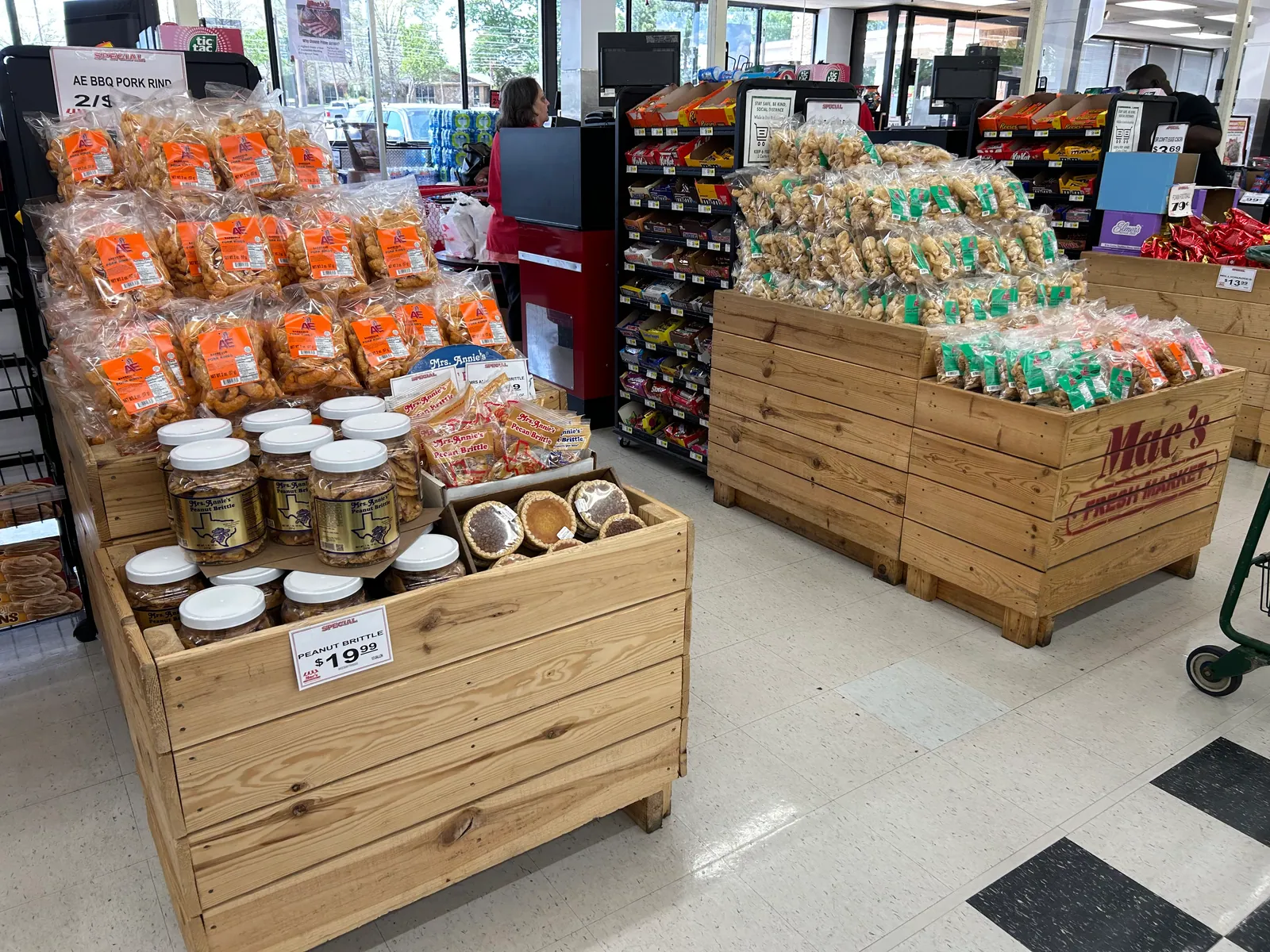Two wooden retail bins at Mac’s featuring pork skins, peanut brittle, pies, and regional products